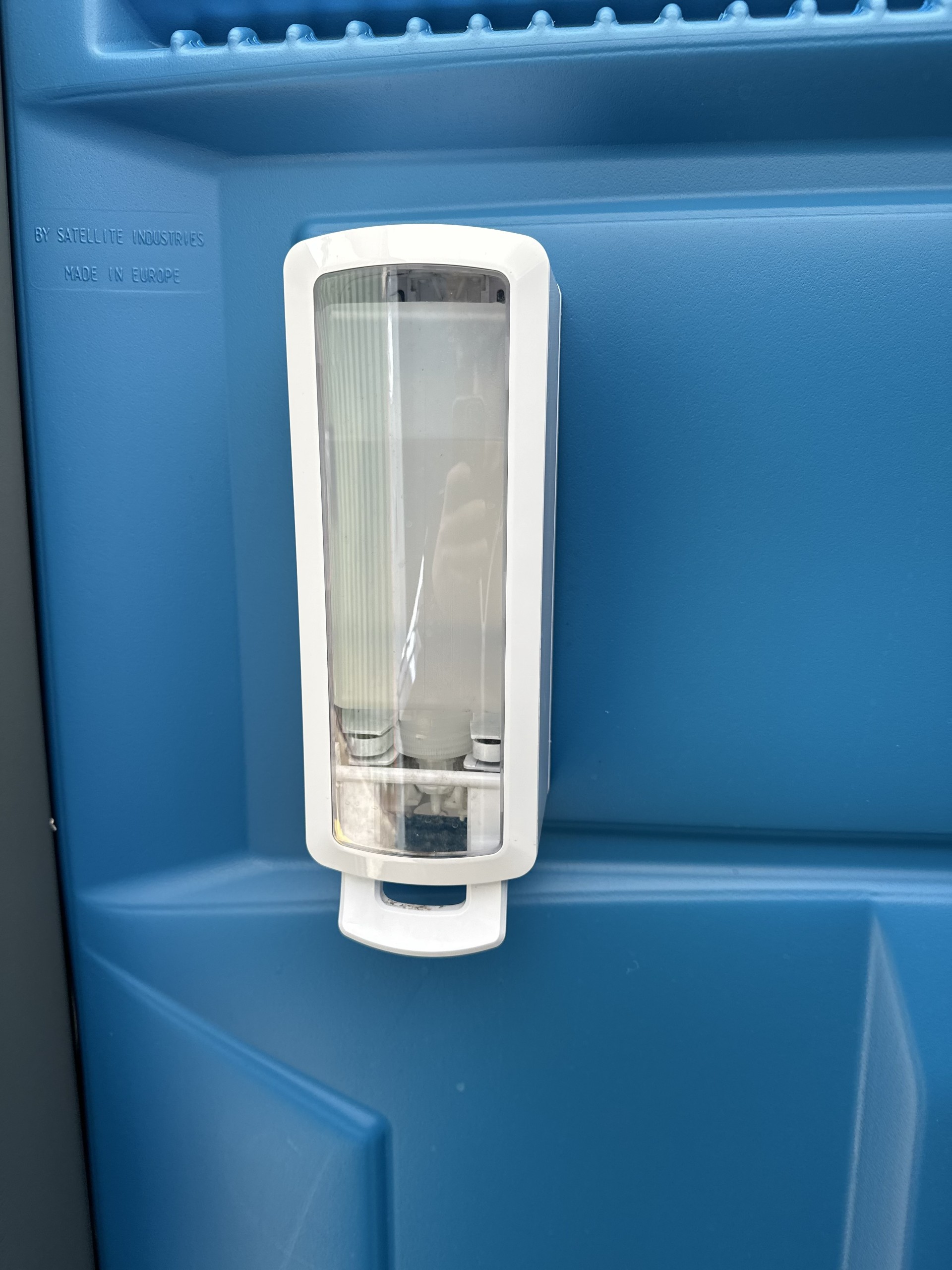 Hand sanitiser dispenser inside a 1 & 2's Loo Hire unit — supplied fully stocked
